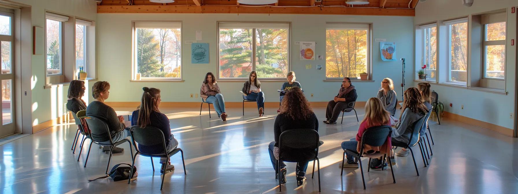 an inviting and modern treatment center in massachusetts, featuring serene indoor spaces and engaged individuals participating in a dynamic group therapy session, conveying hope and transformation in recovery.